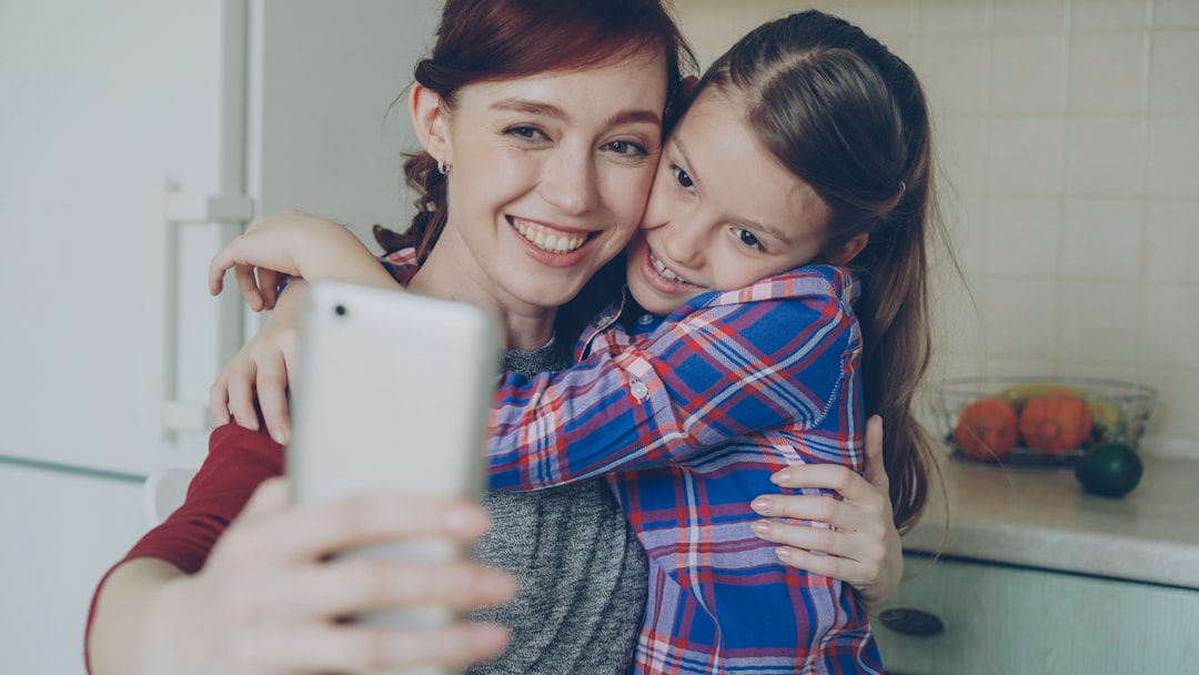 子どもとスマホを見る親子